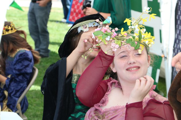 Candace Fernandez helps adjust Bella Kline’s hairpiece.