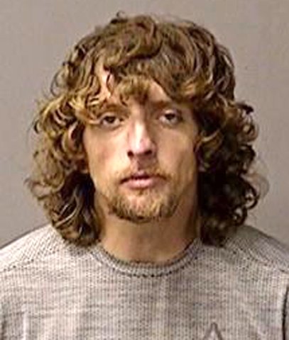 Loiterer found behind business arrested on warrant