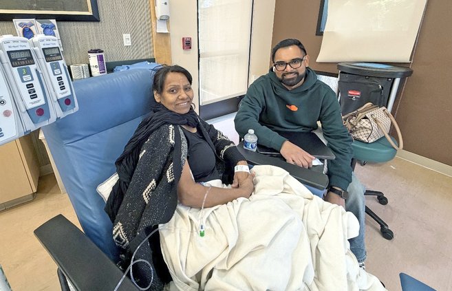 Nevin Shoker sits with his mom Laxmi