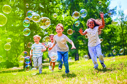 kids playing with bubbles